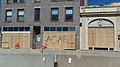 "ACAB" spray painted on a boarded up building.jpg