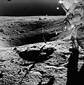 John Young stands on the rim of Plum Crater while collecting lunar samples.jpg