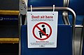 "Don't sit here" sign on a seat in a TriMet bus for social distancing during COVID-19 pandemic.jpg
